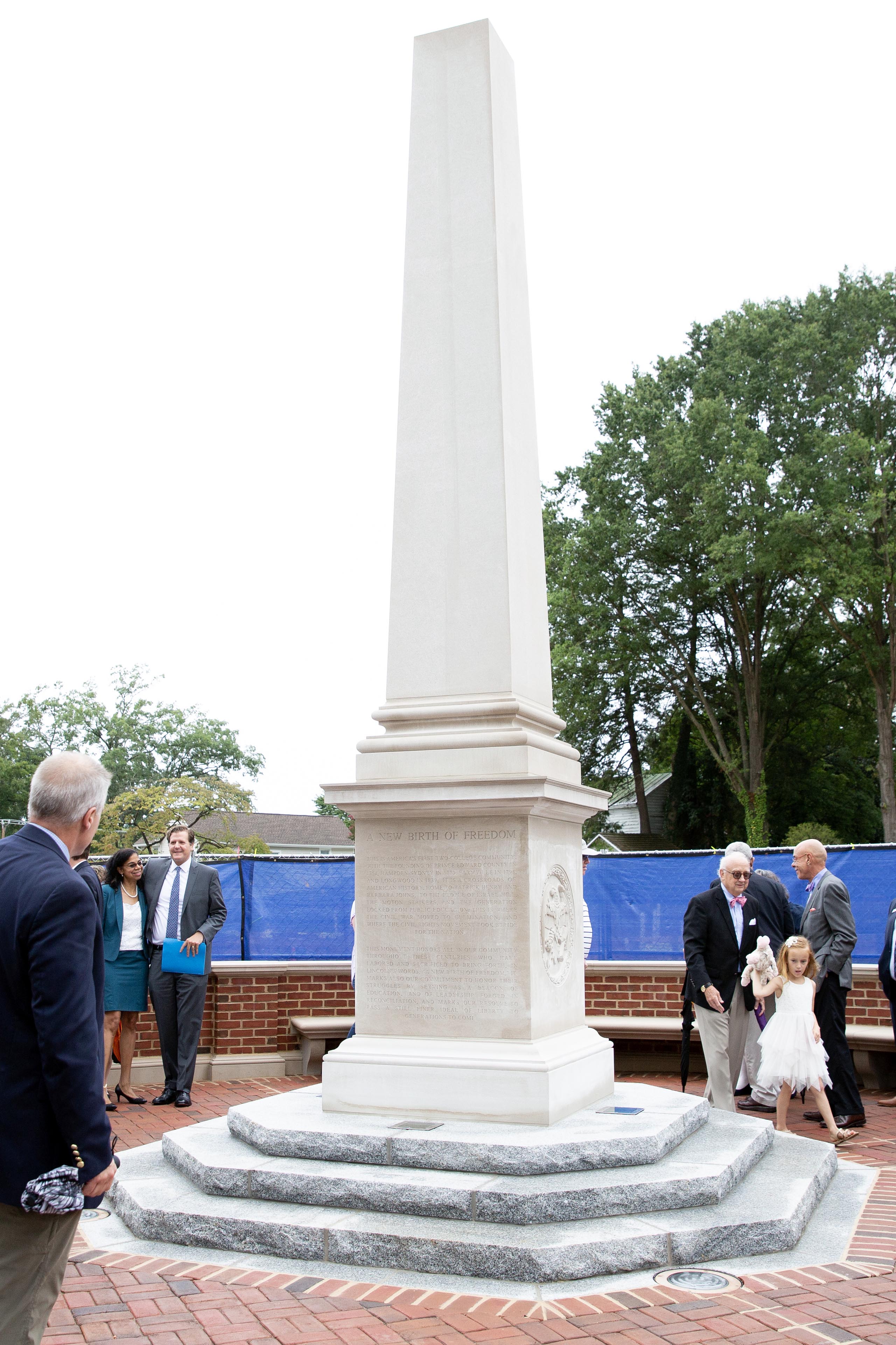 An image freedom monument during its dedication with several onlookers present